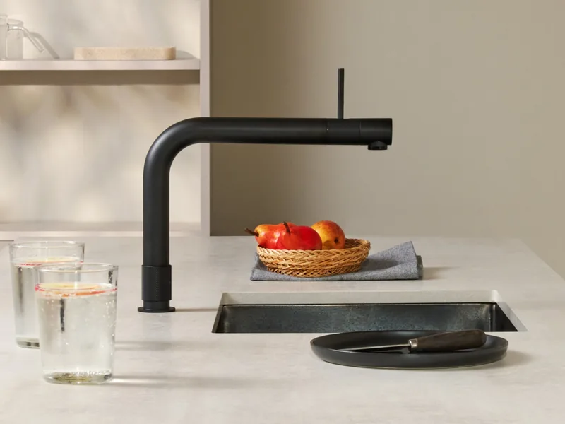 Czarna bateria Front na jasnym blacie, minimalistyczna kuchnia — Quooker