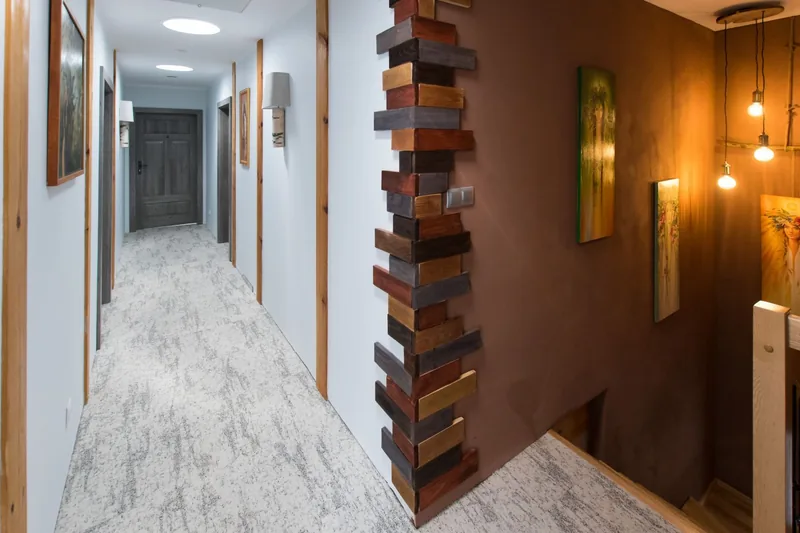 Korytarz hotelowy — jasna wykładzina rolowa — Ampel